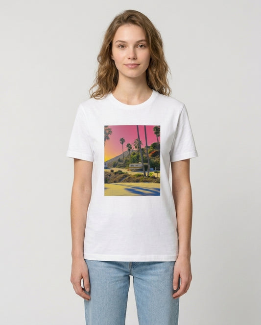 Person wearing a white t-shirt with a colorful graphic design on a plain background
