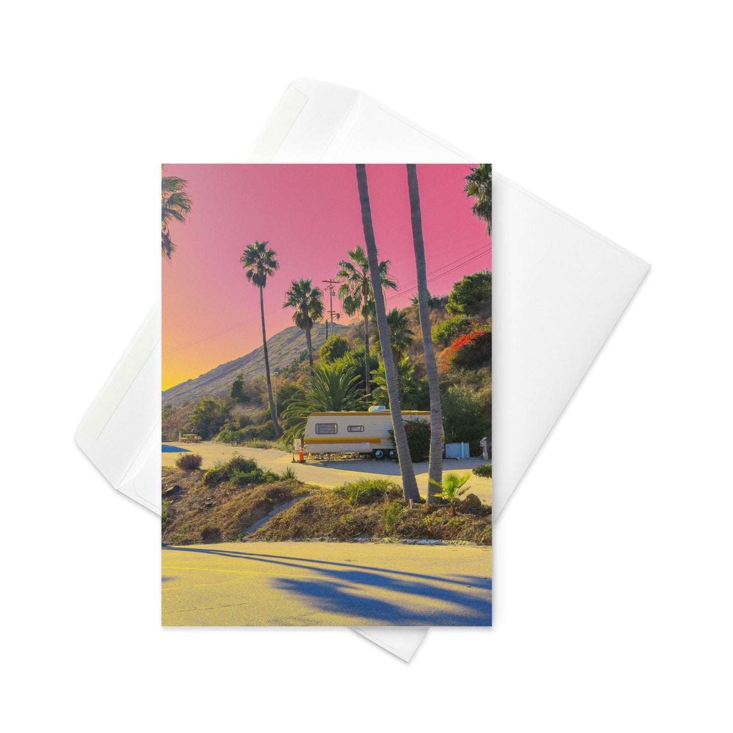 Card with a scenic view of palm trees and a camper van, featuring a pink sky.