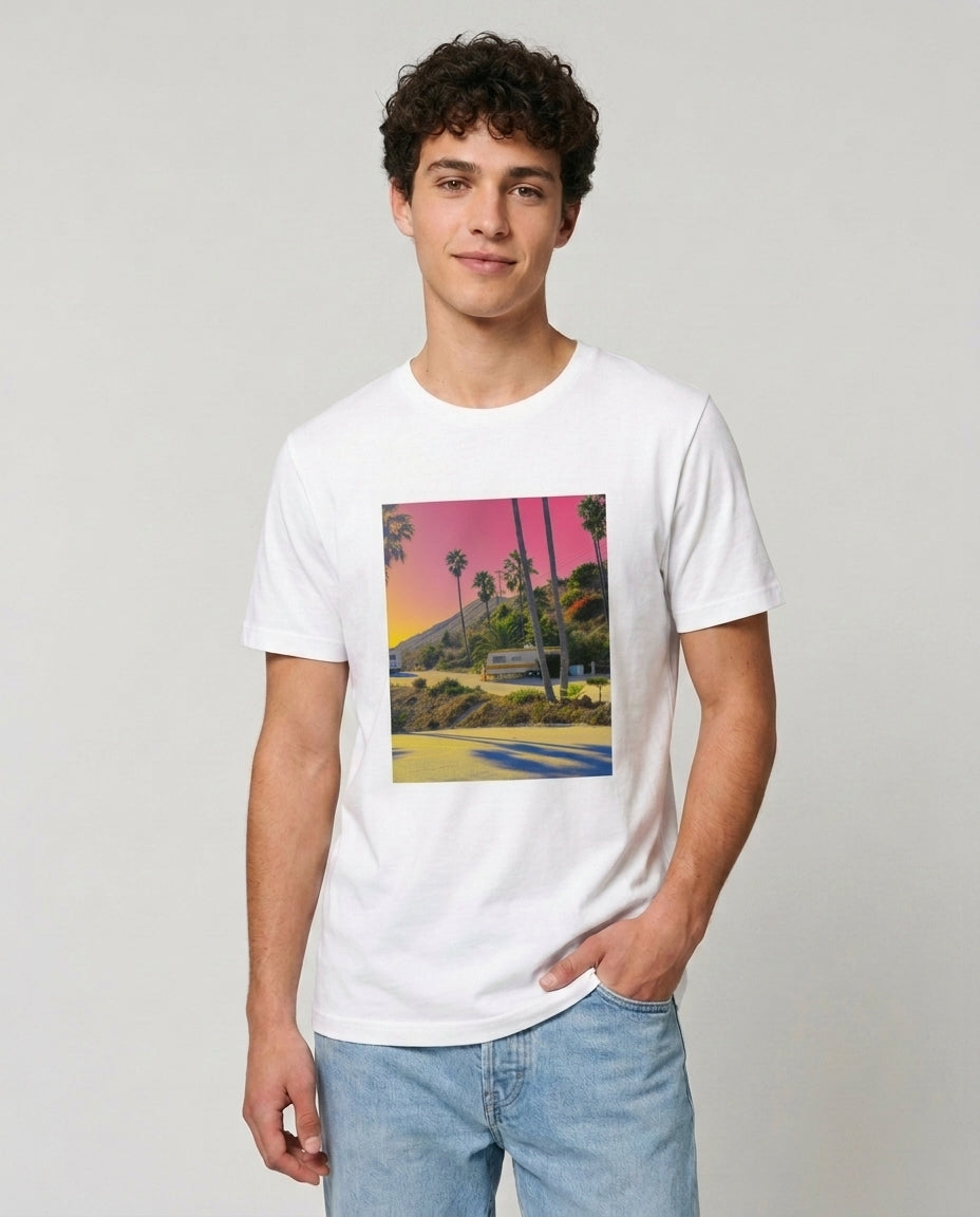 Person wearing a white t-shirt with a colorful graphic design on a plain background