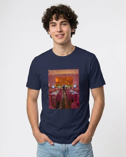 Person wearing a navy blue t-shirt with a colorful graphic design on a plain background