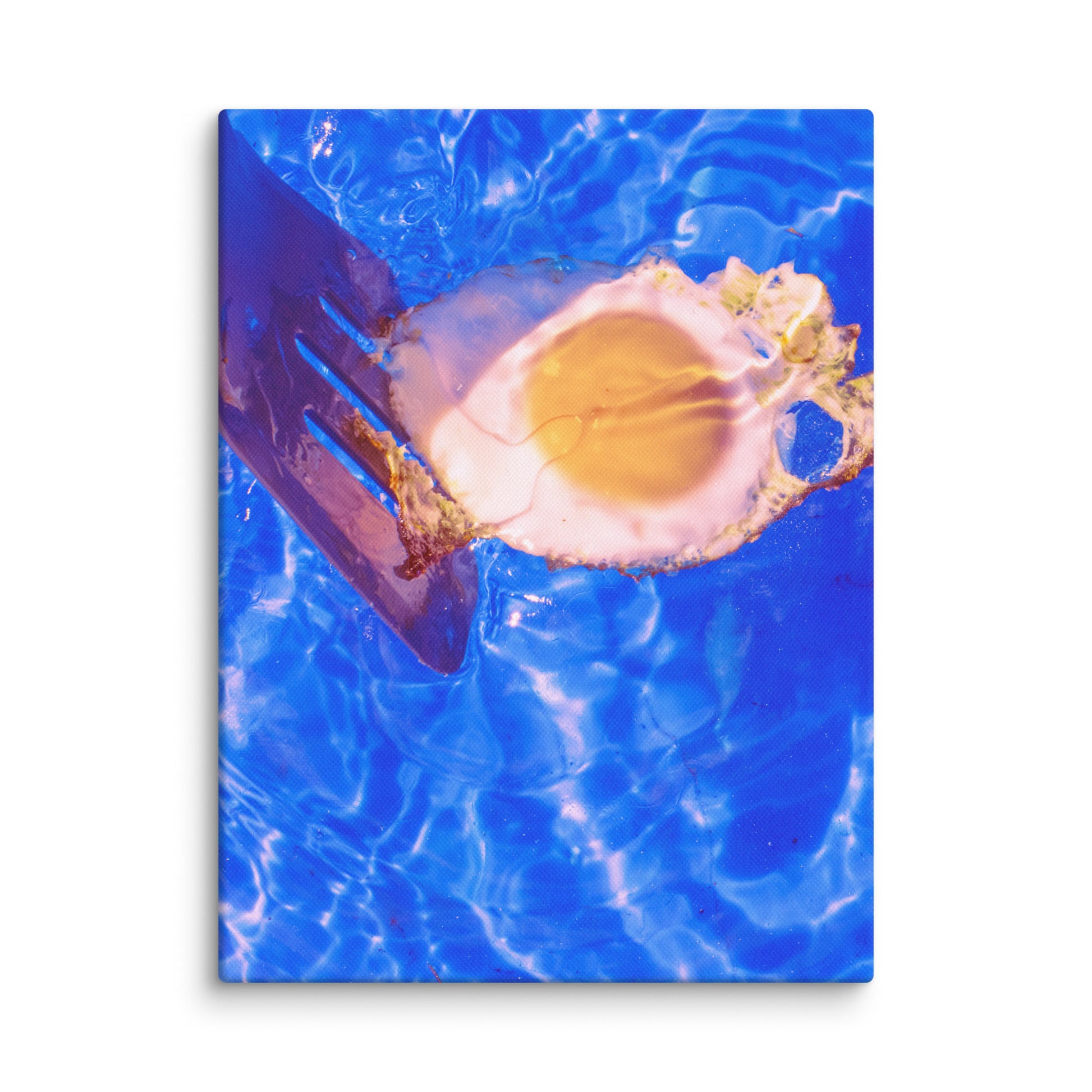 Canvas print of a fried egg with a spatula on a blue water background