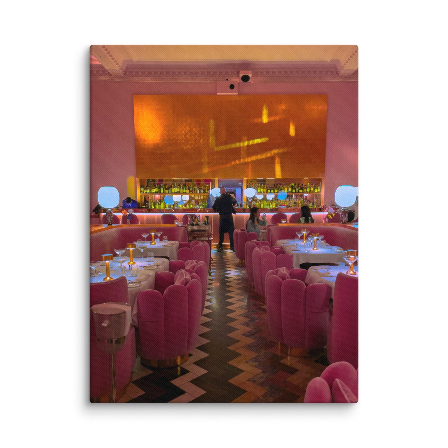 Pink-themed restaurant interior with tables and chairs, and a bar area.