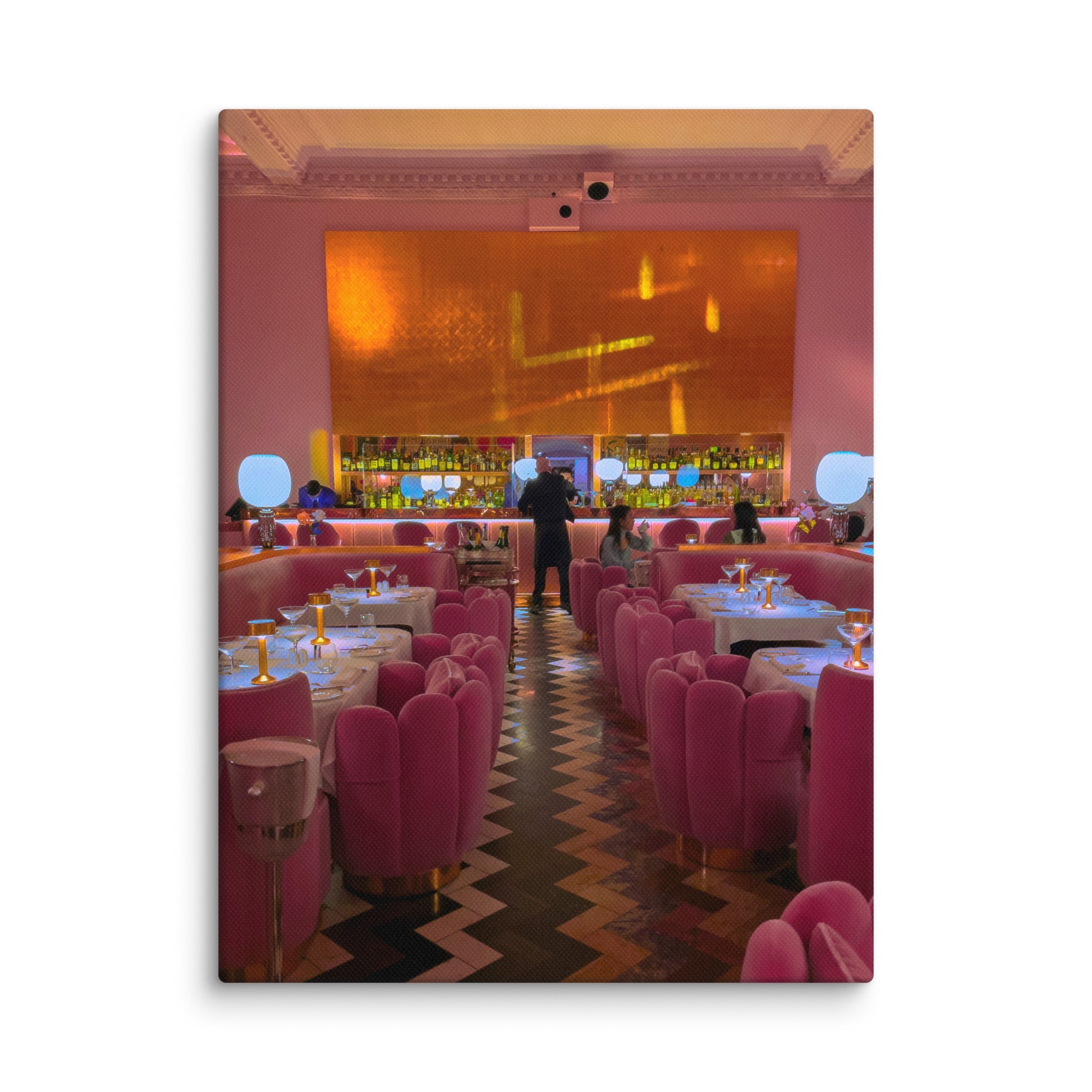 Pink-themed restaurant interior with tables and chairs, and a bar area.