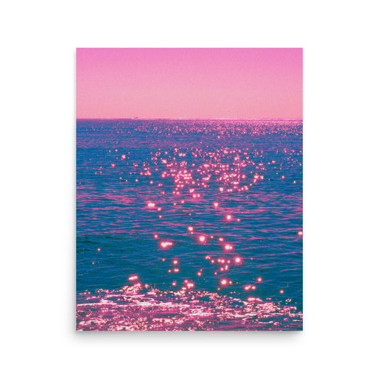 Pink and blue gradient over water with pink reflections