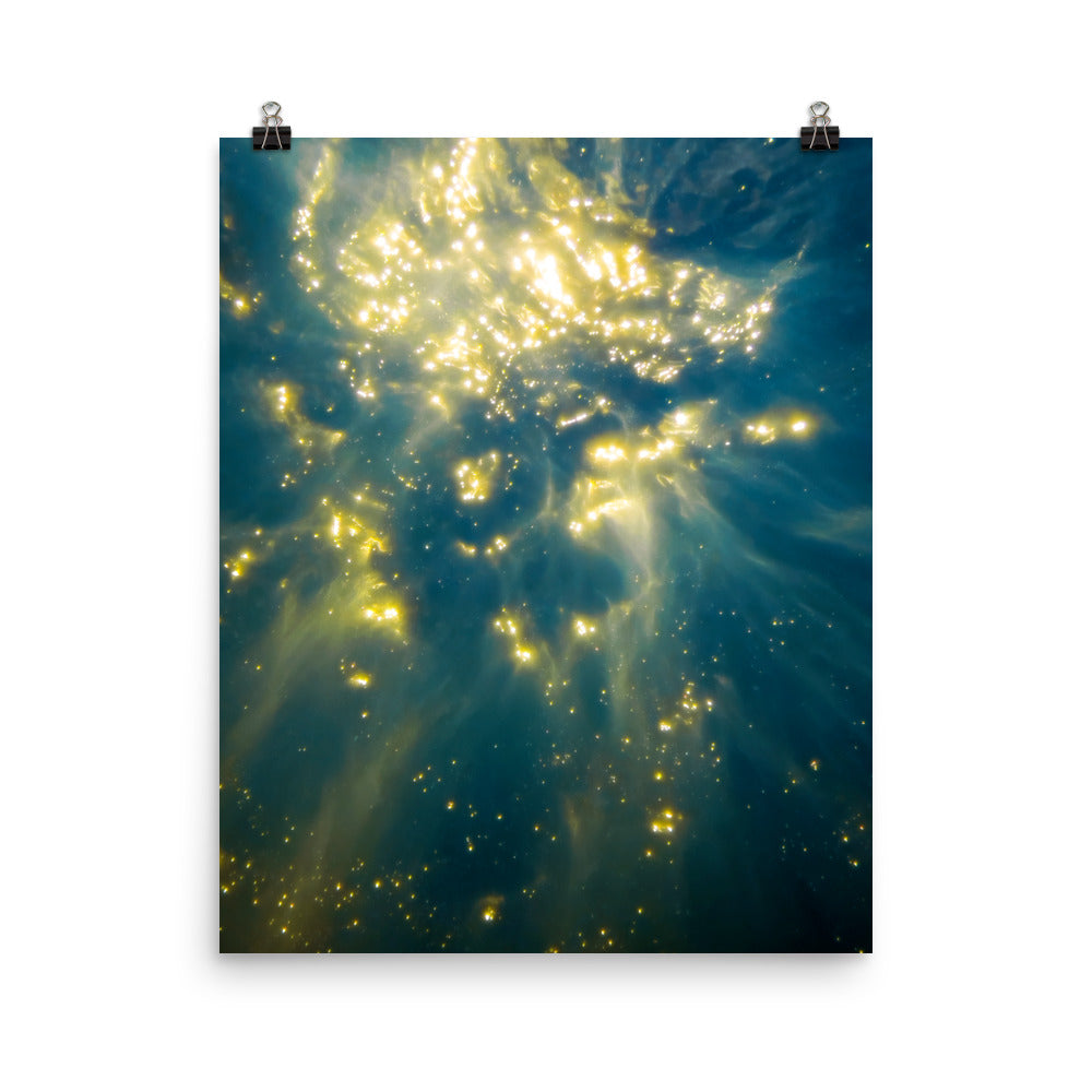 fine art poster print of abstract underwater sunlight, gold light particles scattered across deep teal ocean water, cosmic seascape wall art displayed on a white wall