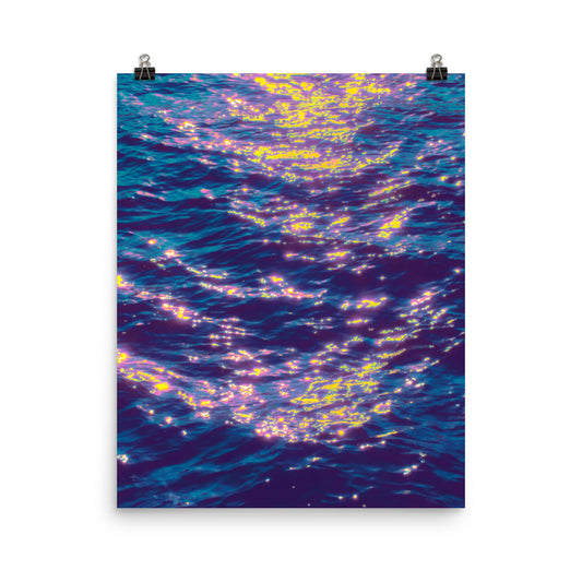 Poster print fine art ocean photography, deep violet and teal water surface scattered with electric yellow and soft pink light reflections, coastal wall art
