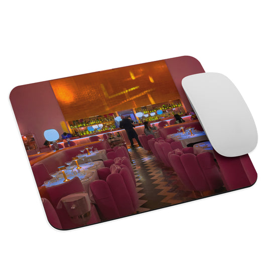 Mouse pad with a bar scene design and a white mouse on top
