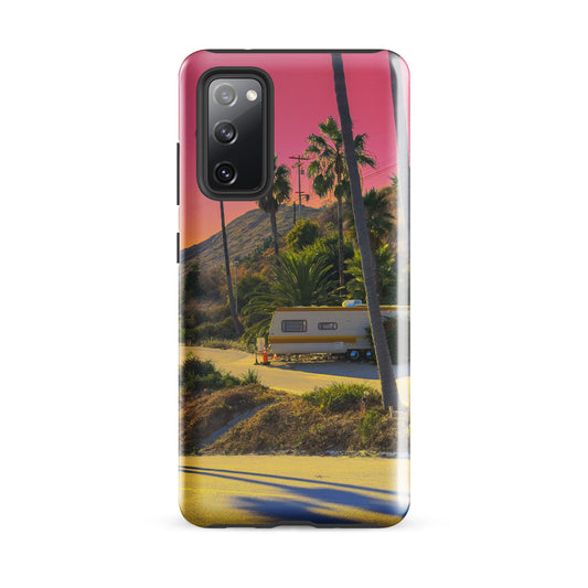 Phone case with a scenic design of a road, trailer, and palm trees at sunset.