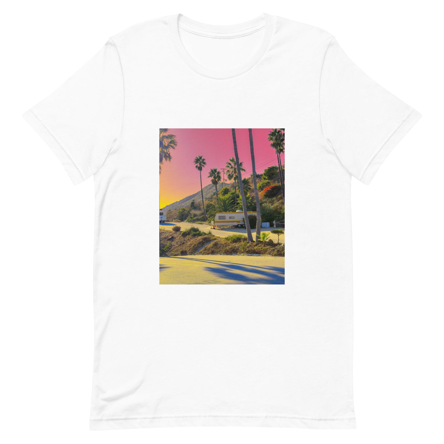 White t-shirt with a scenic print of palm trees and a pink sky on a white background